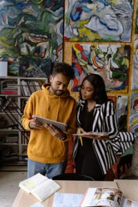 Two designers collaborating in an art-filled office space, enhancing creativity and innovation.